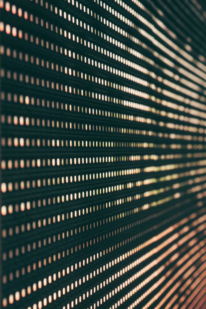 hero-img-01 Abstract image featuring a close-up of an LED panel with glowing light patterns.