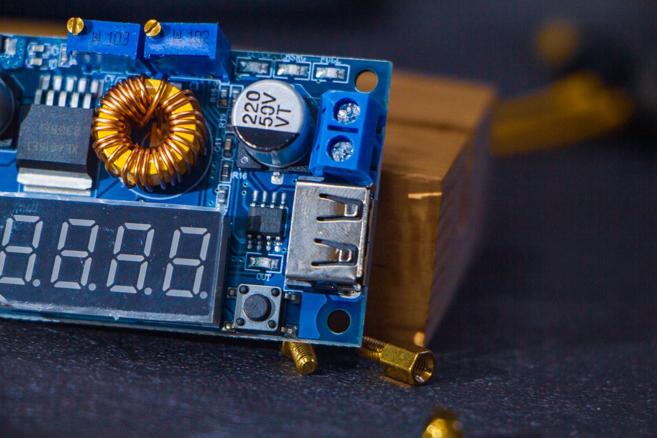 gallery-4 Detailed shot of a blue electronic circuit board featuring components and a USB port.
