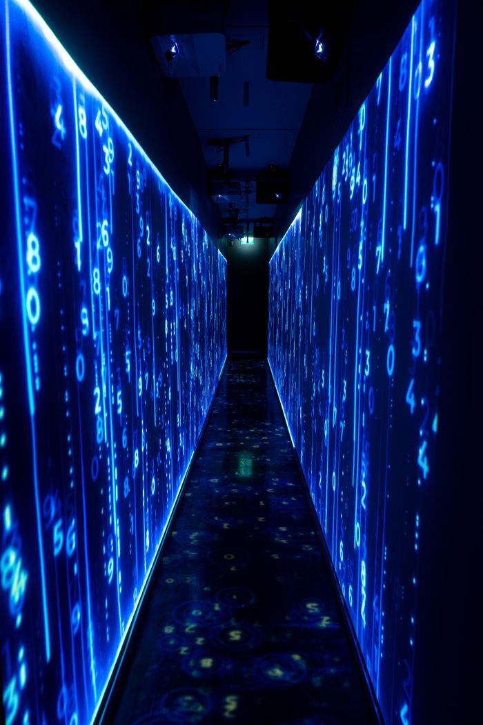 services-02 A luminous blue tunnel with digital numbers creating a futuristic, sci-fi ambiance.
